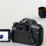 Image of a camera photographing a mug of coffee