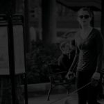 Banner image of woman in sunglasses walking her dog