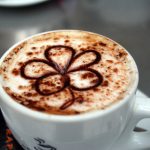 Image of a coffee with a chocolate flower on top