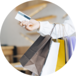 A customer with shopping bags handing over his card