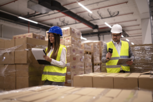 warehouse-workers-using-bar-code-scanner-tablet-checking-goods-inventory