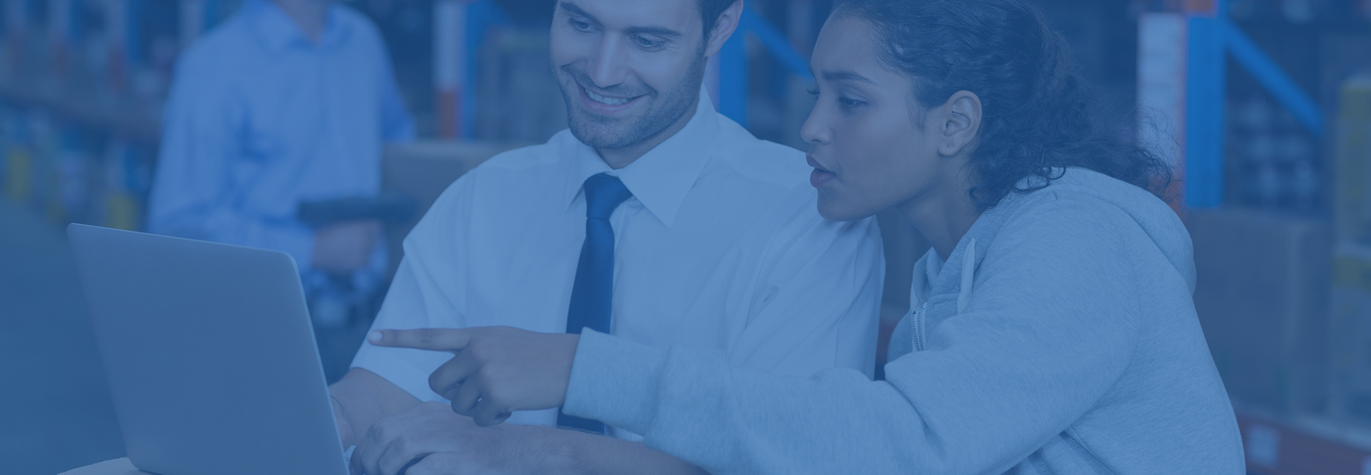 smiling-workers-pointing-laptop